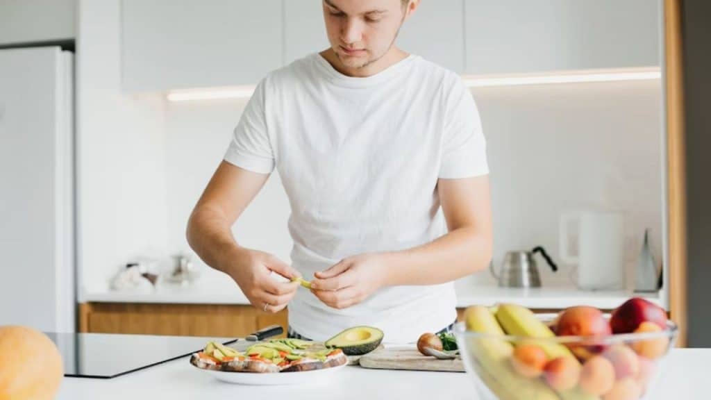 Man preparing a healthy meal with vegetables and lean protein