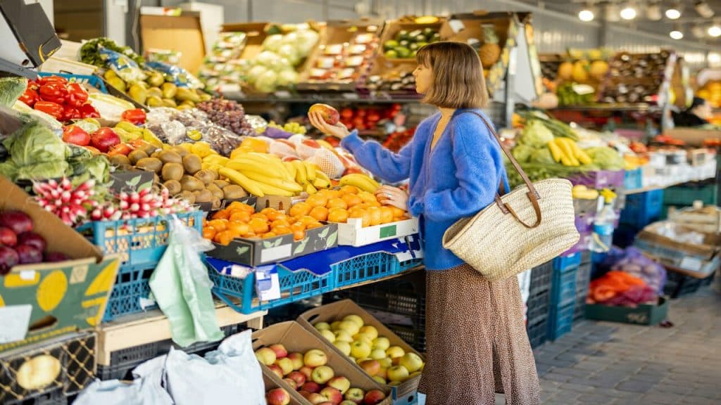A woman inspecting fruits in the market