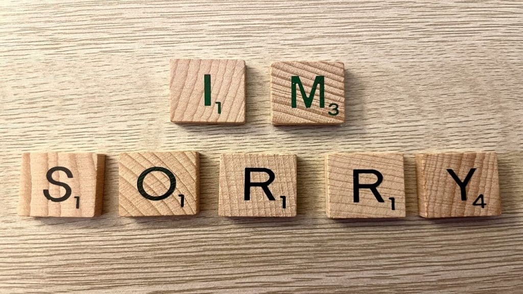 Wooden blocks spelling out “I’m sorry”