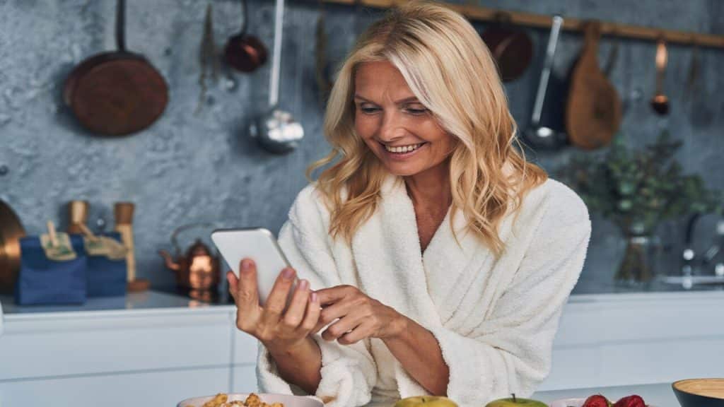 A beautiful woman smiling at her phone