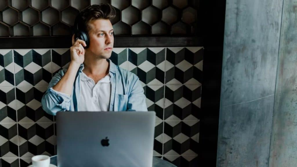 Man sitting alone listening to music in a quiet room