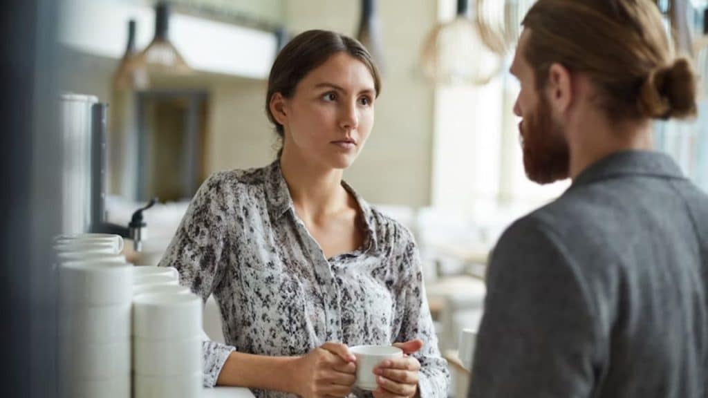 Woman raising eyebrows in annoyance during a date