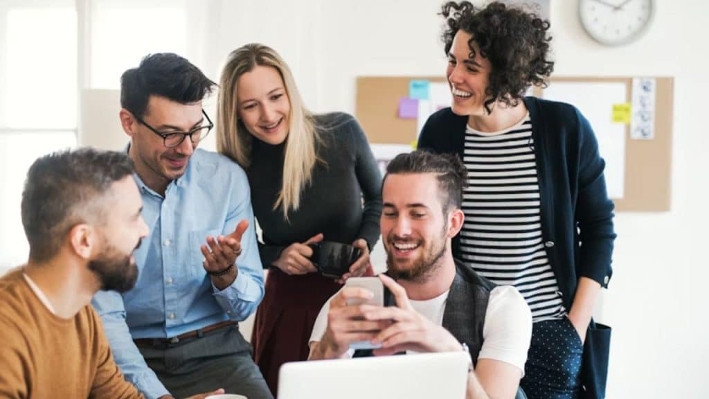 Man giving a confident smile while sitting in a meeting