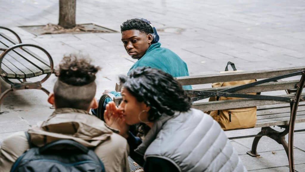A man looking at his girlfriend gossiping