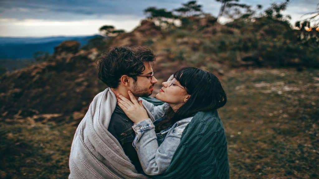 A couple hugging in a field