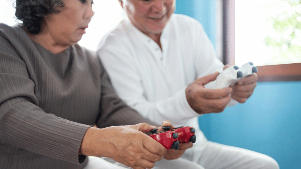 An East Asian couple plays video games, each holding a controller.