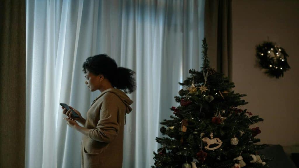 A woman looking sad and alone at Christmas