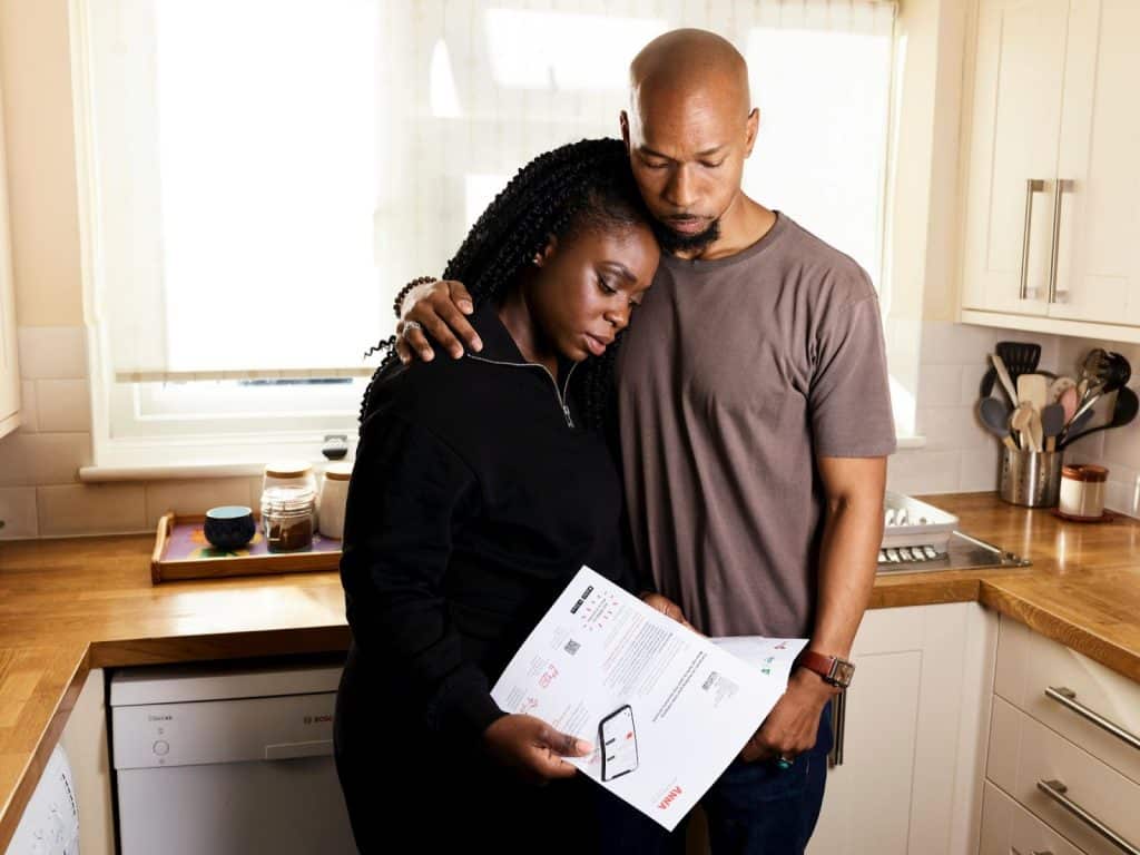 A man and woman checking their finances