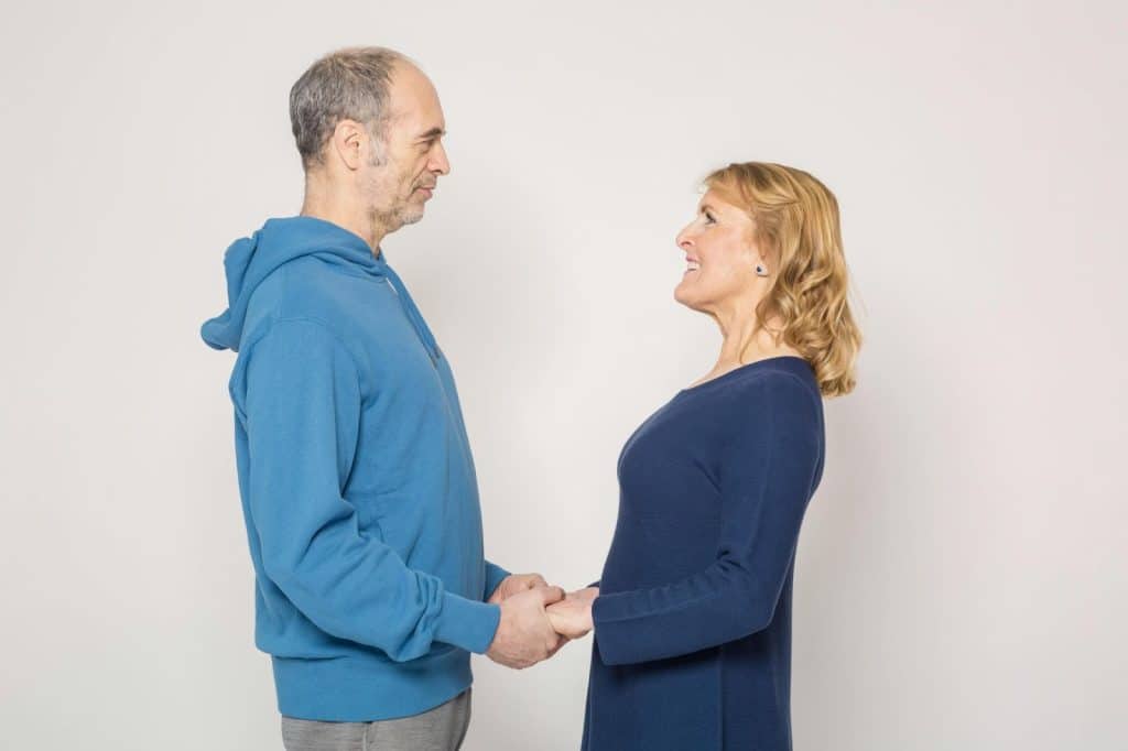 A man and woman holding each other’s hands