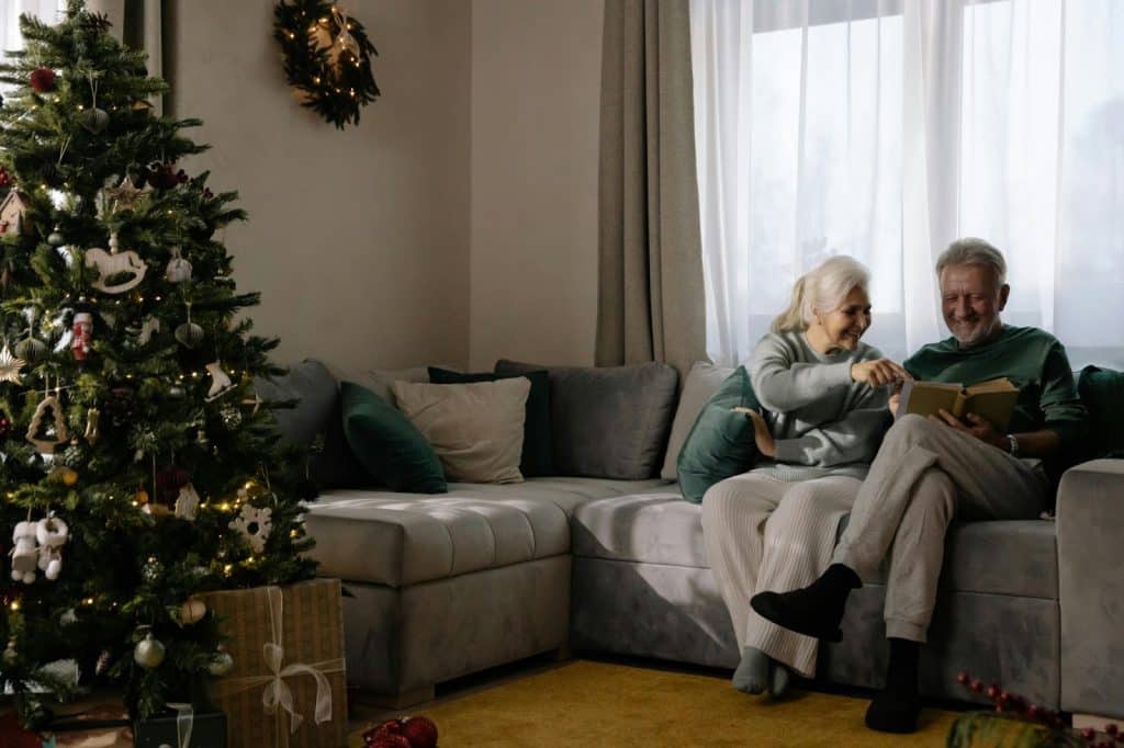 A man and woman reading a book 
