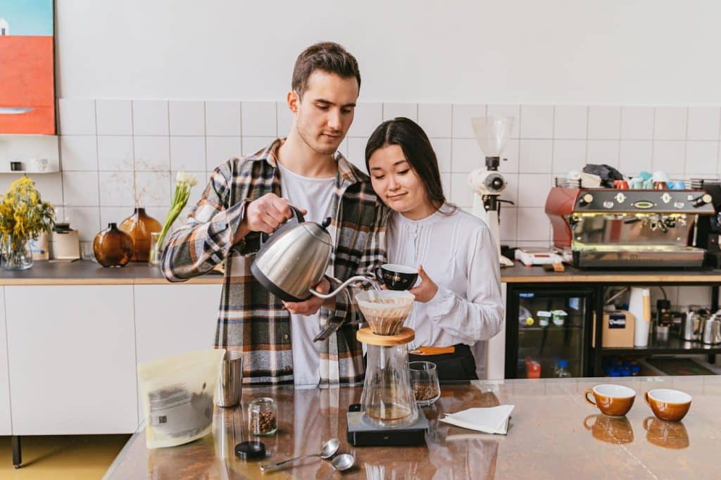 A man and woman making a coffee