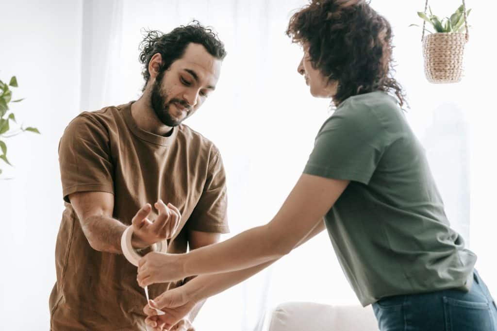 A woman helping a man