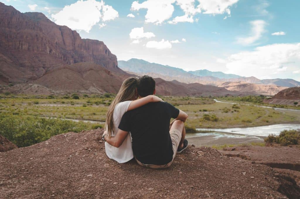 A man and woman sitting on the ground