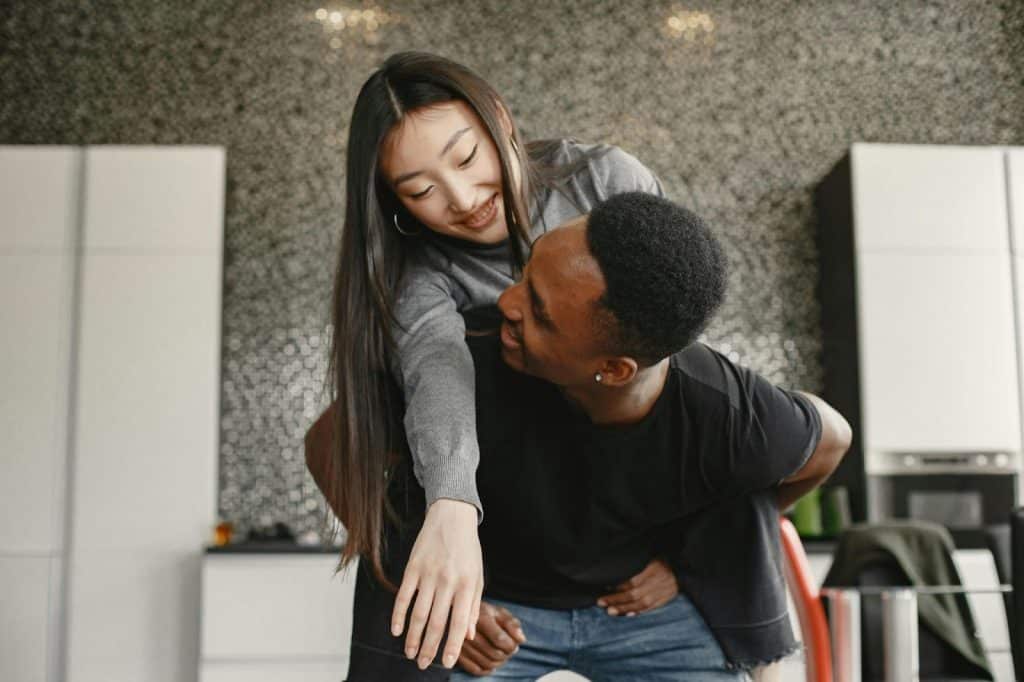 A man carrying a woman on his back