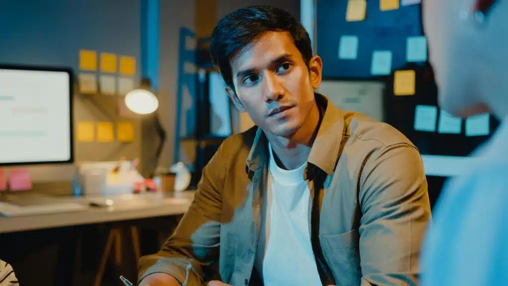 A man in an office listening attentively.