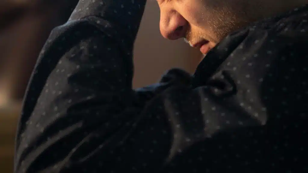A man holds his head looking stressed.