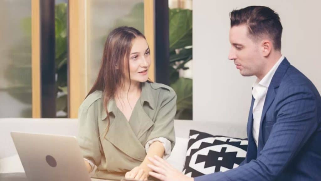 Woman frowning while speaking as man listens politely