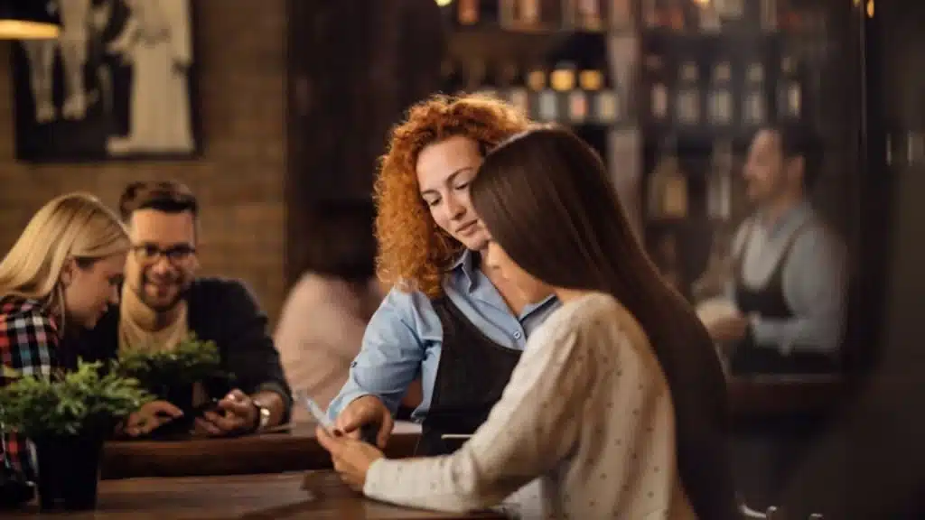 Woman speaking sharply to a restaurant server