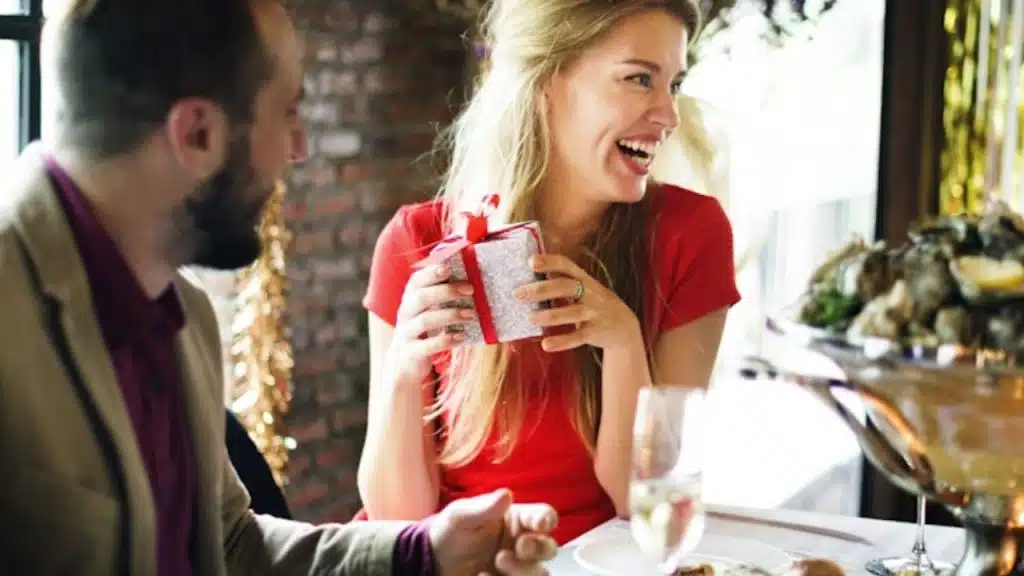 Woman happy with her gift and talks about money at dinner