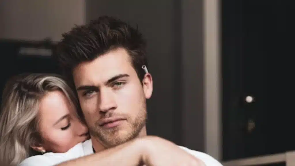 Man looking uncomfortable while woman leans in too closely