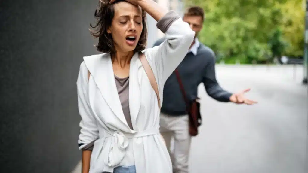 Woman gesturing negatively while man looks drained