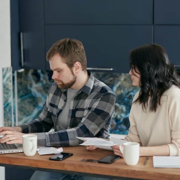 A man and woman checking their finances