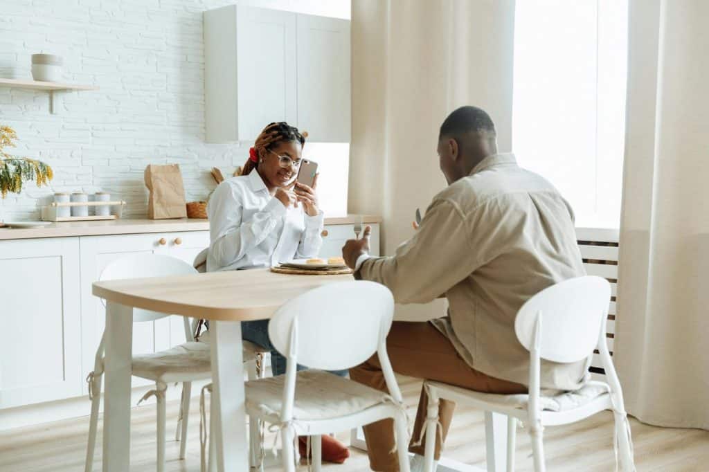 A woman taking a picture of her man