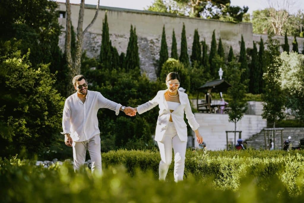 A man and woman holding hands while walking