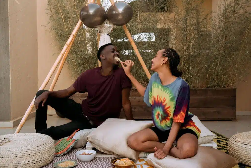 A woman feeding a man