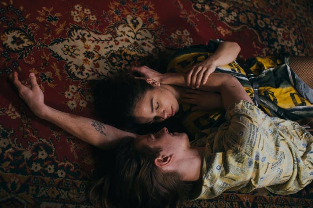 A man and woman laying on the floor