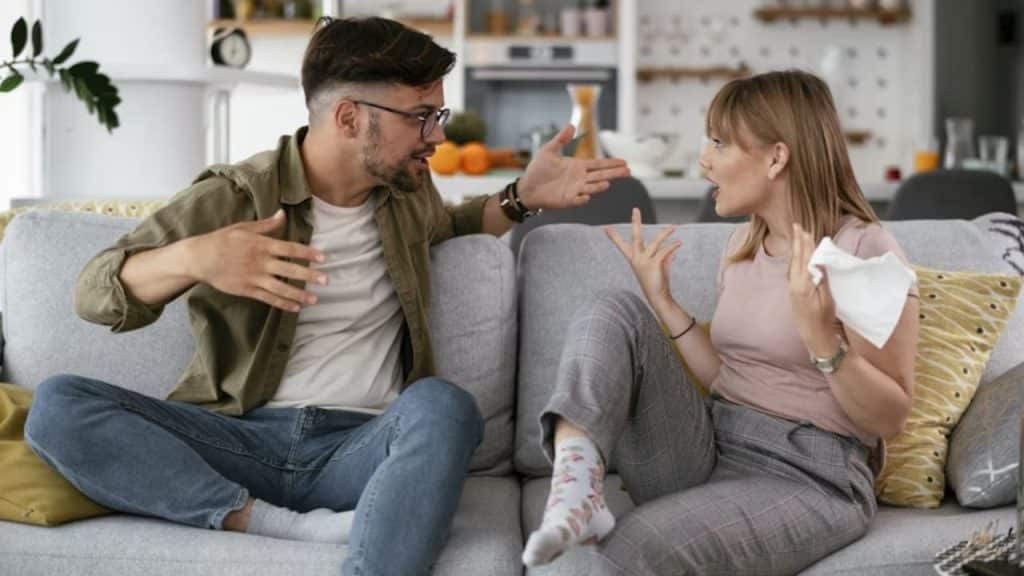 Couple arguing loudly in a living room