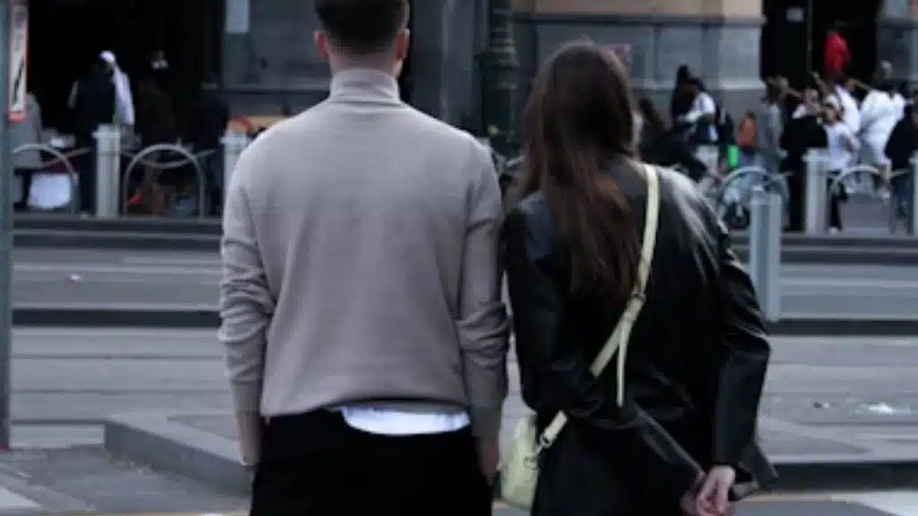 Couple walking together but looking distant