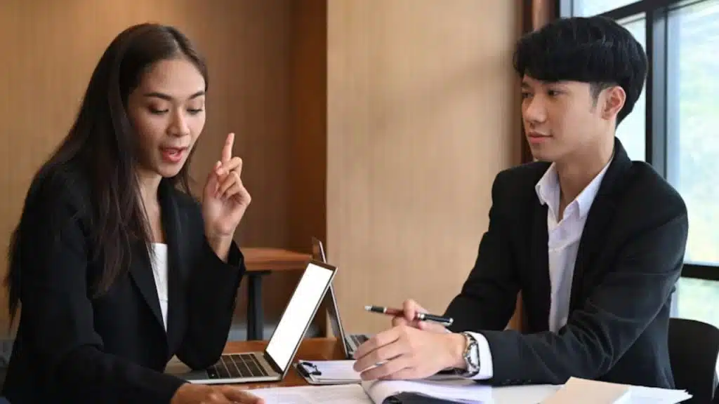 Couple arguing about a decision while holding paperwork