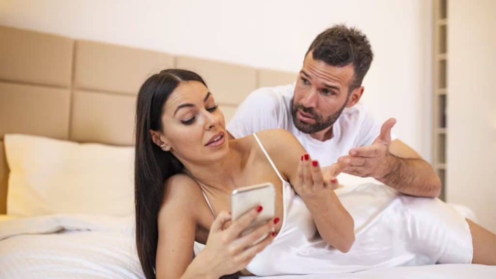 Man wanting to check his partner’s phone suspiciously
