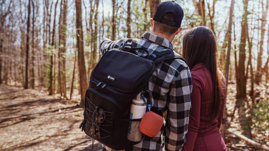 A couple hiking together in the woods.
