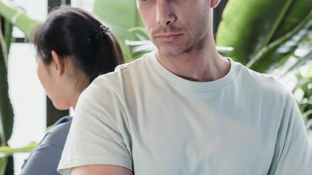 A man and woman standing behind each other.