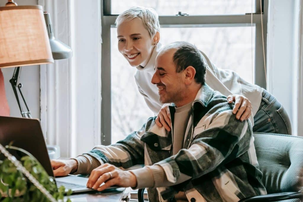 A woman supporting a man