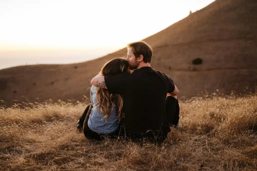 A man kissing a woman’s forehead
