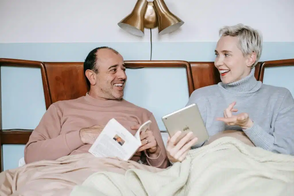 A man and woman reading their own choice of book