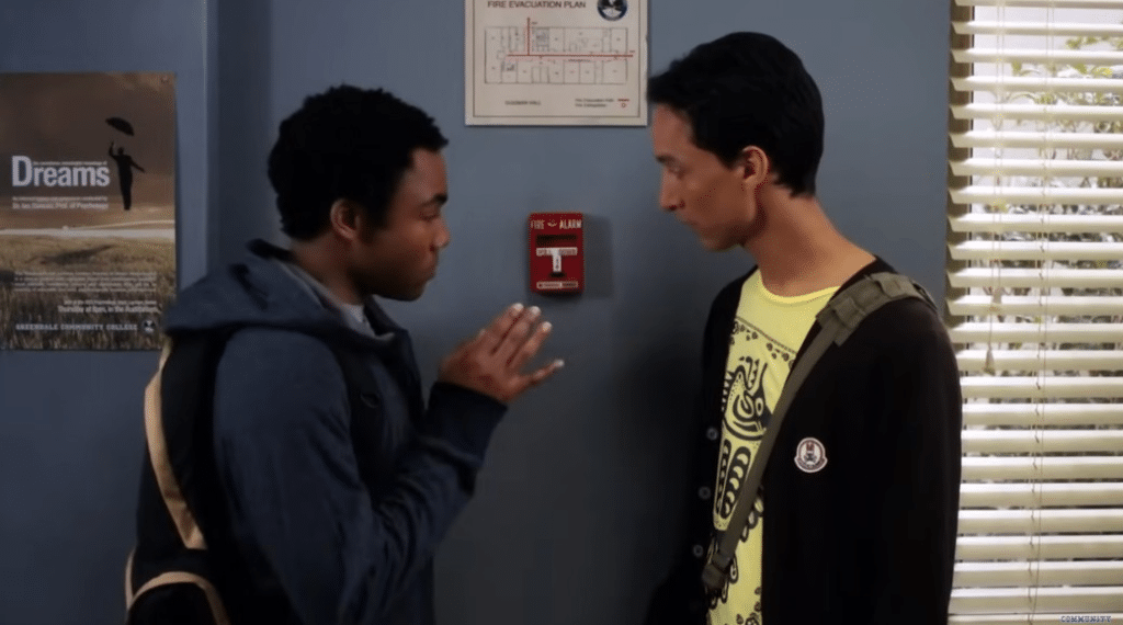 A picture of two boys in front of fire alarm