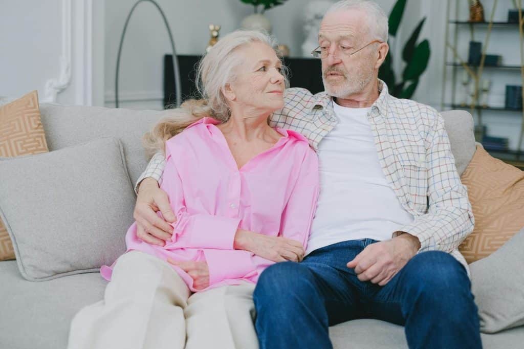 A man and woman sitting at the couch