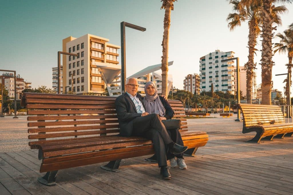 A man and woman sitting at the bench