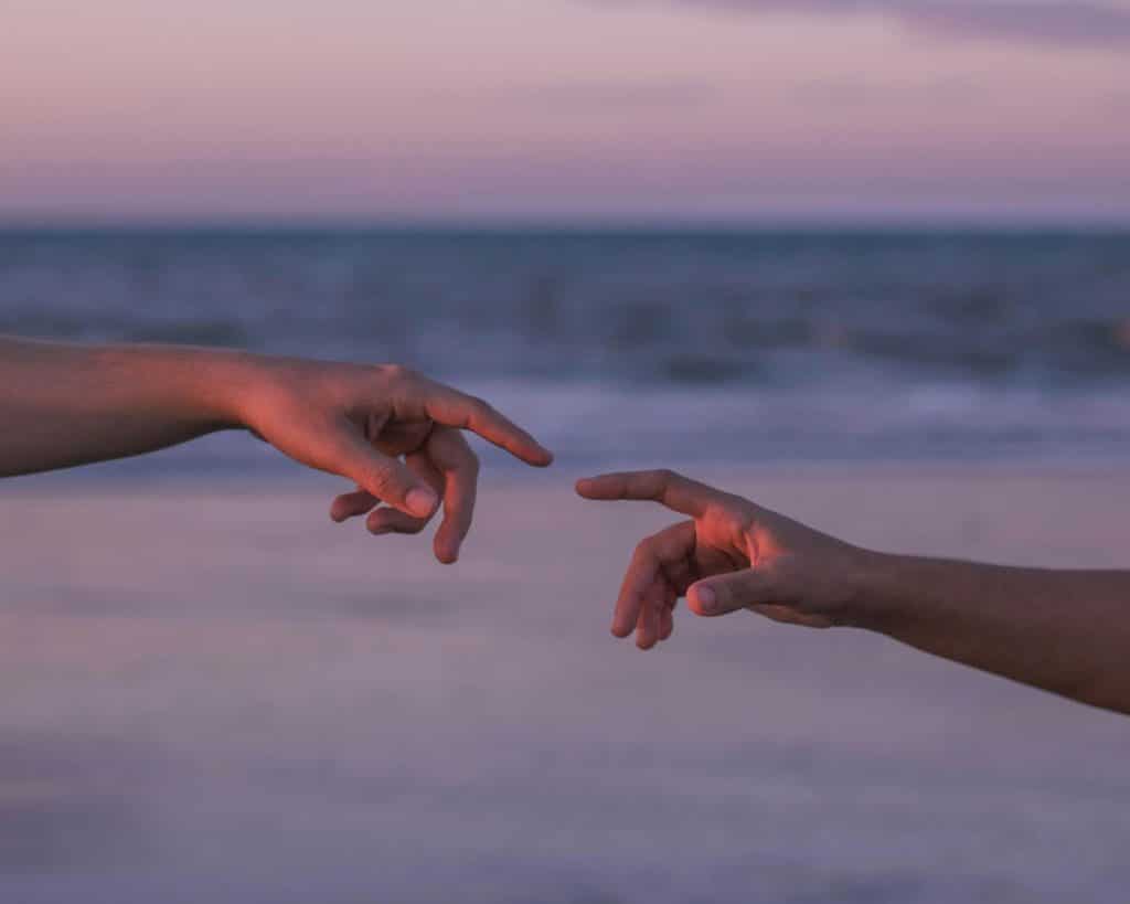 Two person reaching hands
