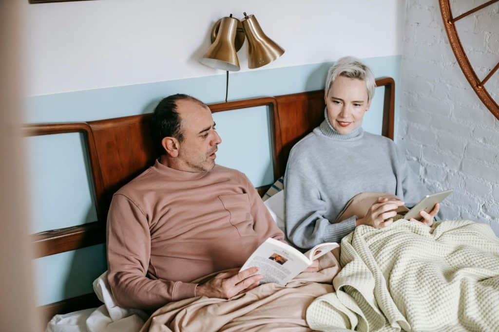 A man and woman at the bed