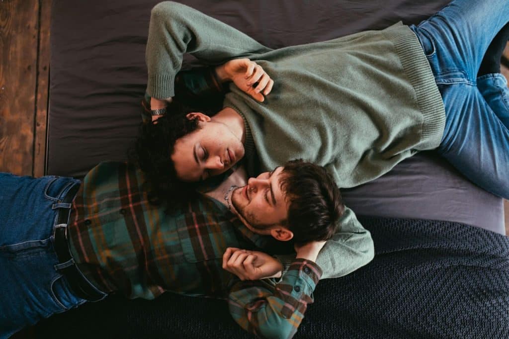 A man and woman laying at the floor