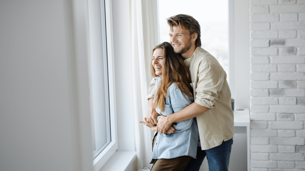 A couple laughing indoors
