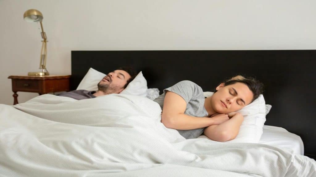 A couple sleeping in bed