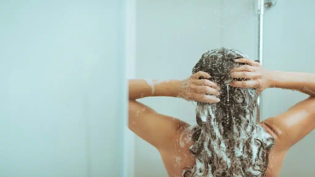 A woman shampooing her hair