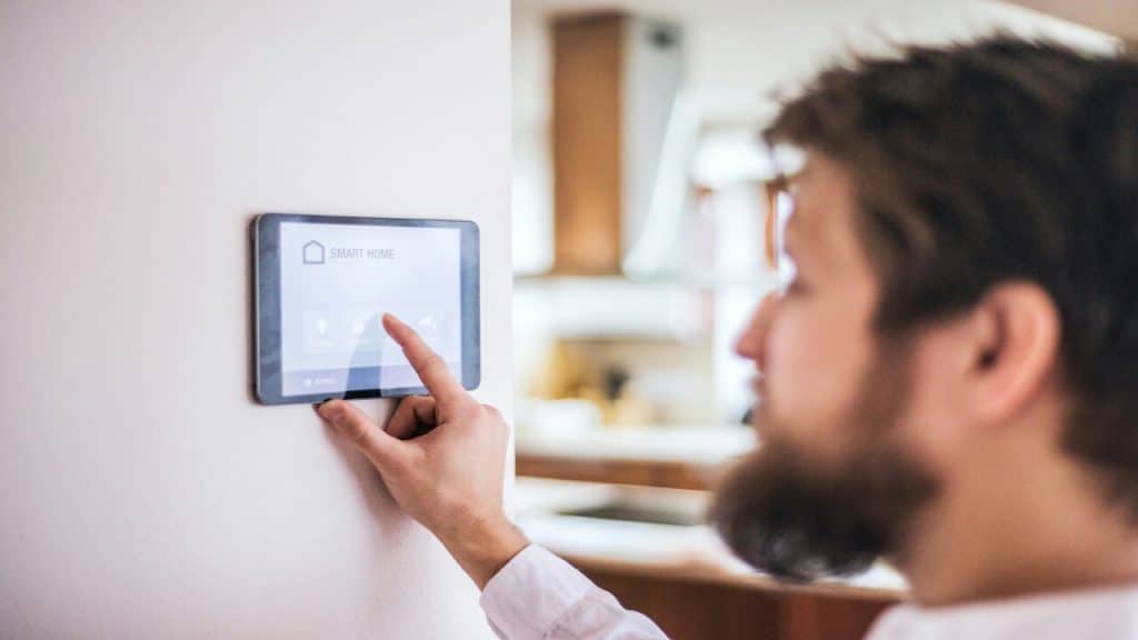 A man setting the thermostat