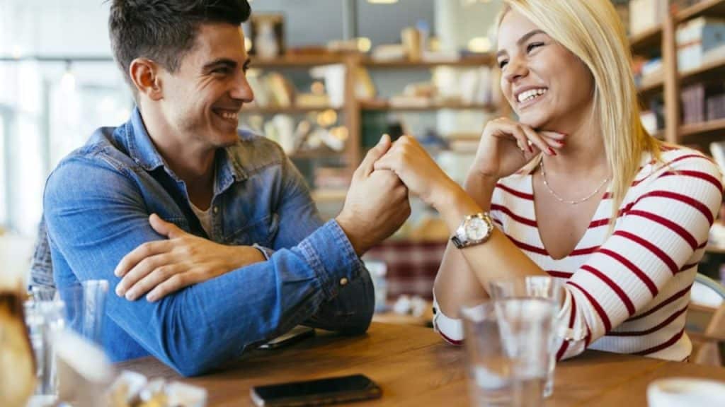 Man putting his phone face down on the table
